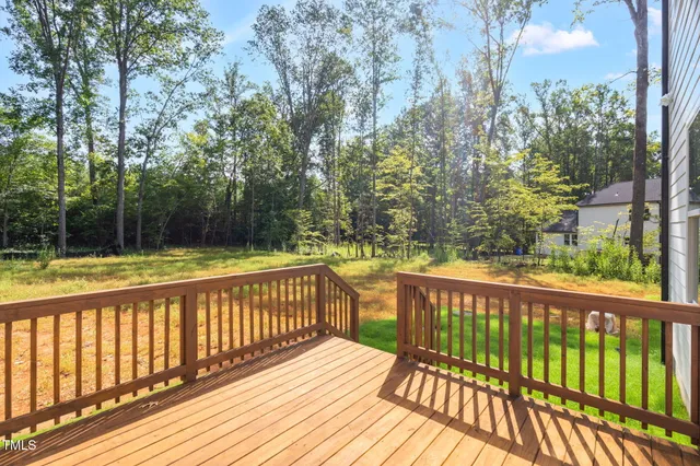 a view of balcony with wooden floor and fence