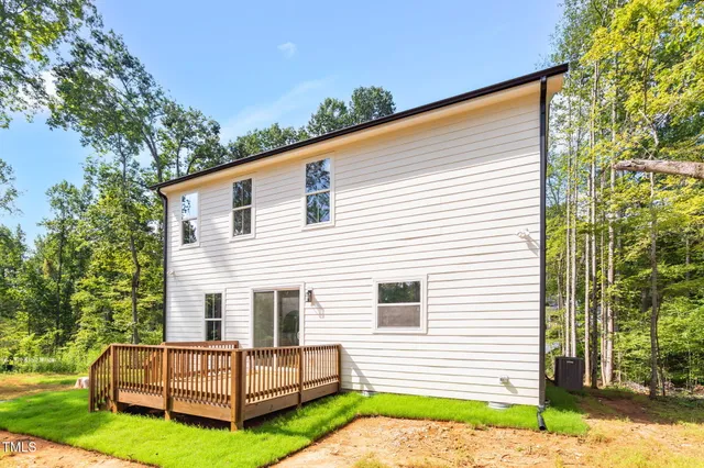 a view of backyard with a garden and deck
