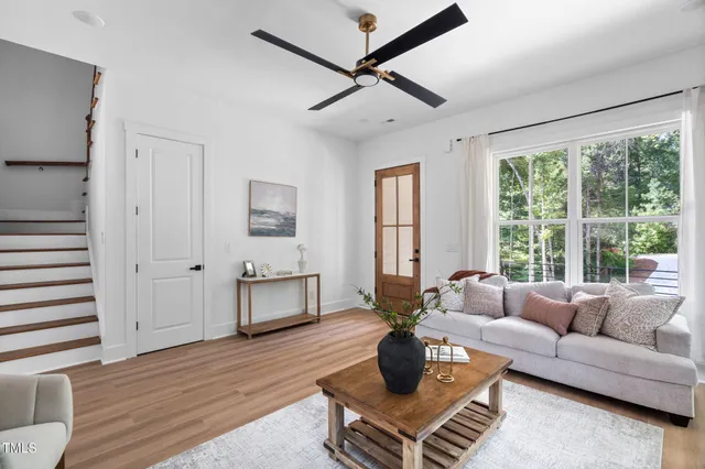 a living room with furniture a window and a table