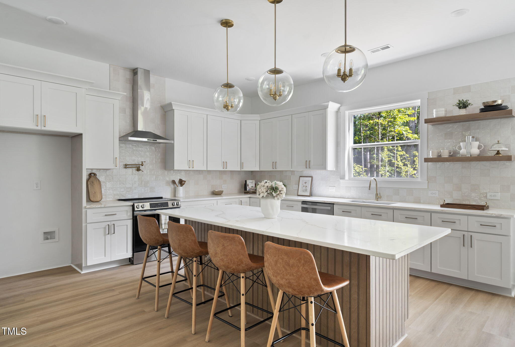 712 Oaks Lane Road Timberlake, NC 27583 - Photo 10 of 47 a kitchen with stainless steel appliances granite countertop a sink a stove a dining table and chairs with wooden floor