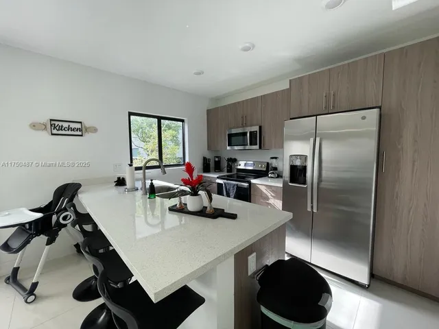 a kitchen with a sink a stove and appliances