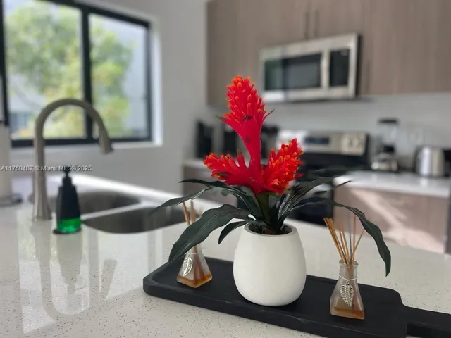 a vase of flowers sitting on a table with six mirrors