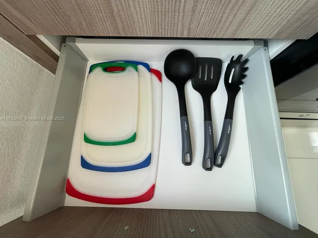 a close view of table chairs and white cabinets