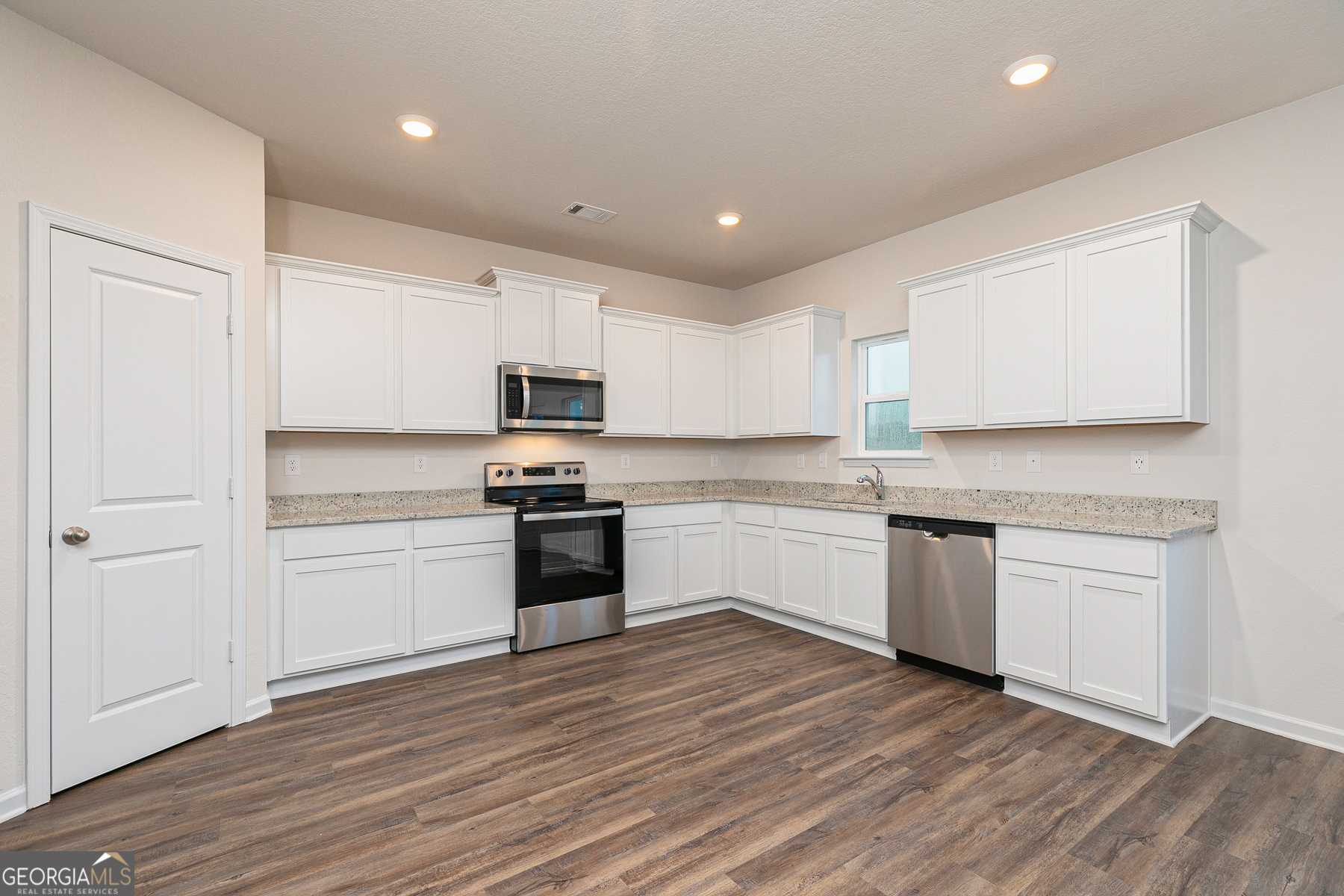 1513 Big Lane Locust Grove, GA 30248 - Photo 11 of 39 a kitchen with granite countertop white cabinets and white appliances