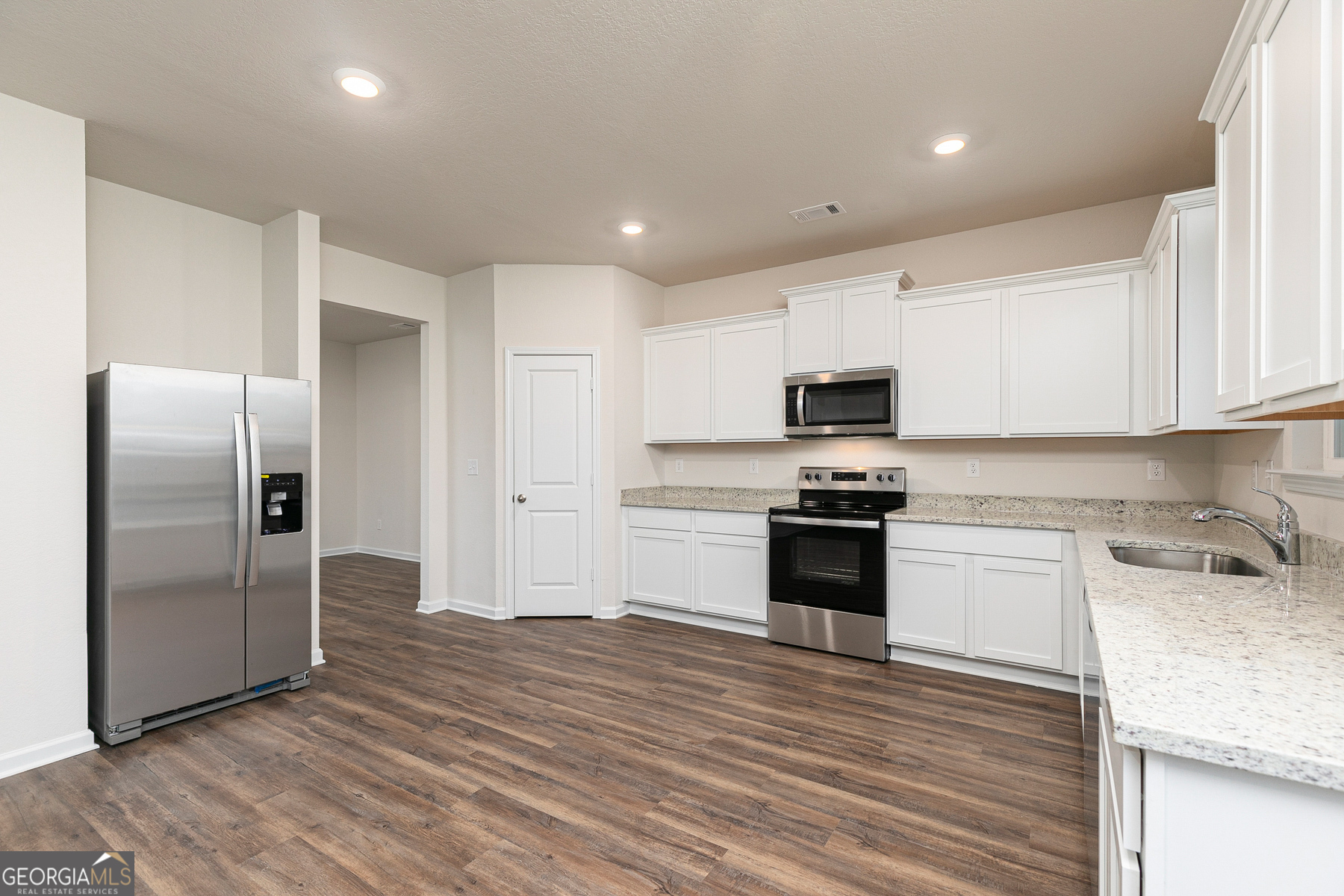 1513 Big Lane Locust Grove, GA 30248 - Photo 12 of 39 a kitchen with granite countertop a refrigerator stove and oven