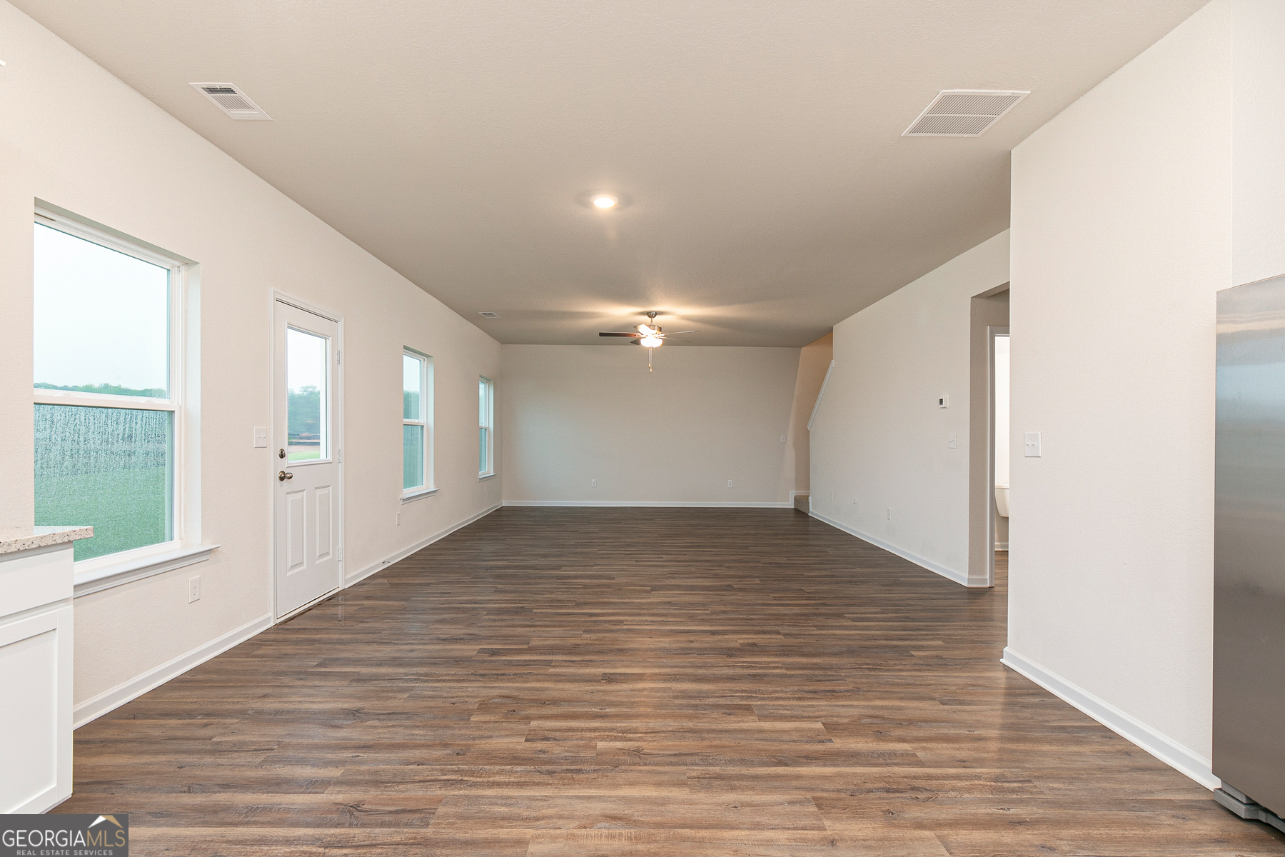 1513 Big Lane Locust Grove, GA 30248 - Photo 13 of 39 a view of empty room with wooden floor and windows