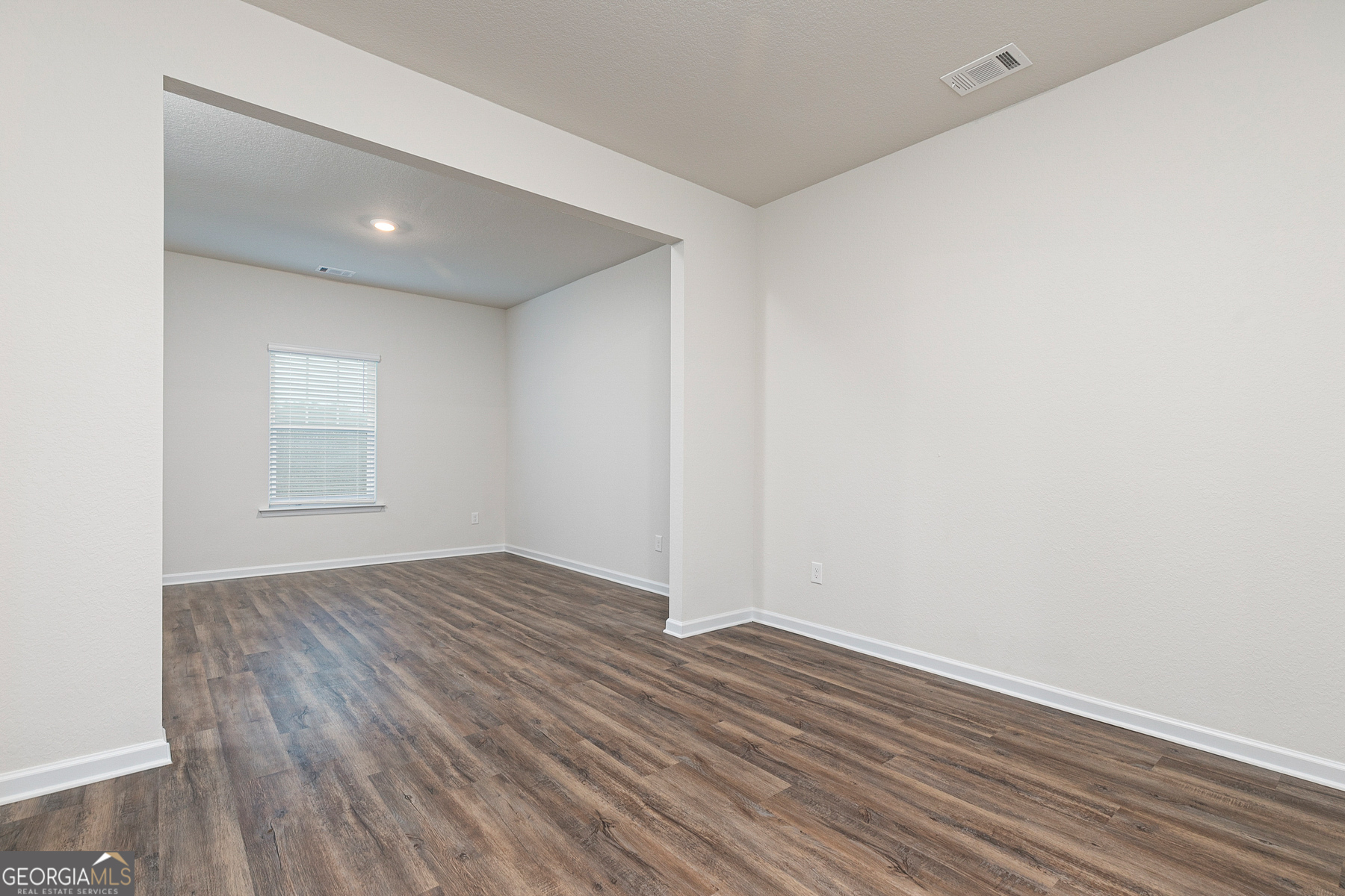 1513 Big Lane Locust Grove, GA 30248 - Photo 6 of 39 a view of an empty room with wooden floor and a window