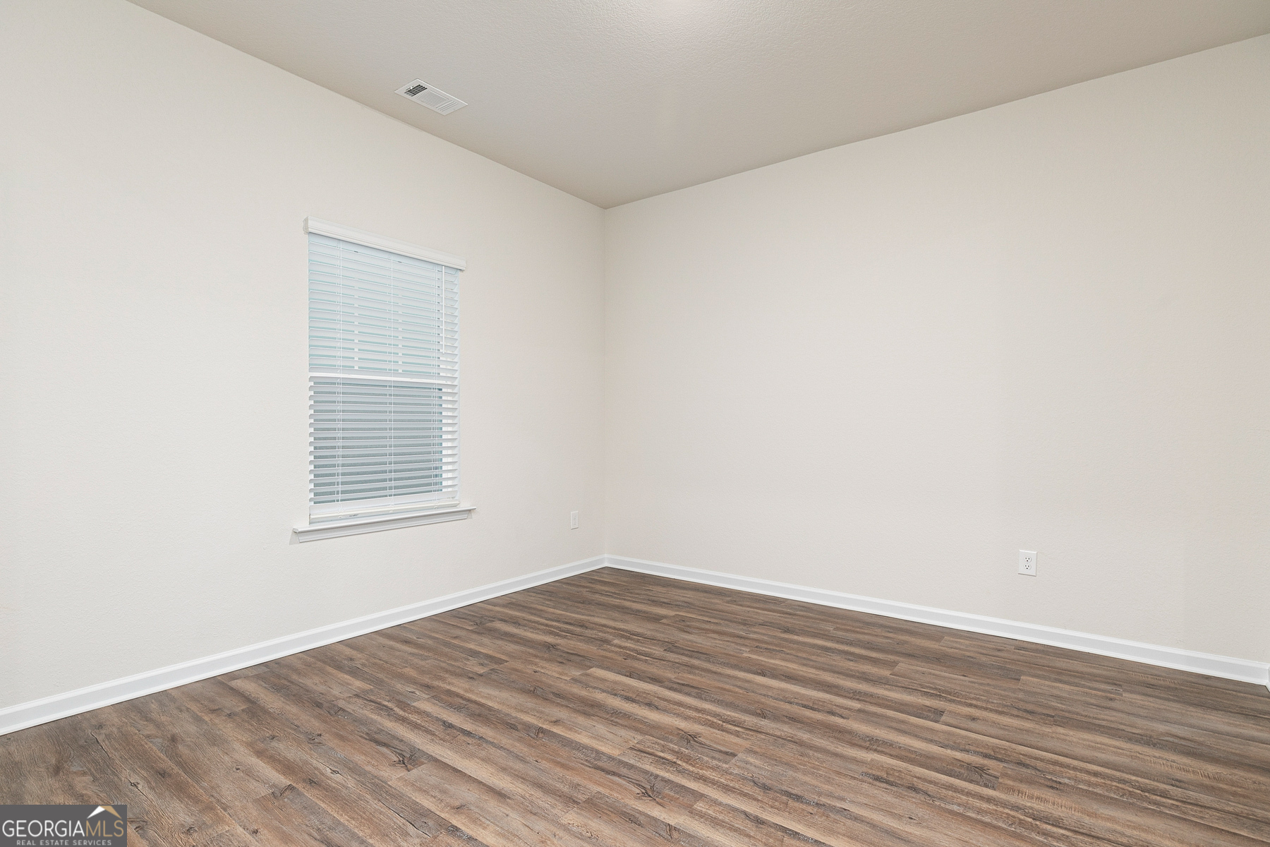 1513 Big Lane Locust Grove, GA 30248 - Photo 7 of 39 a view of an empty room with wooden floor and a window