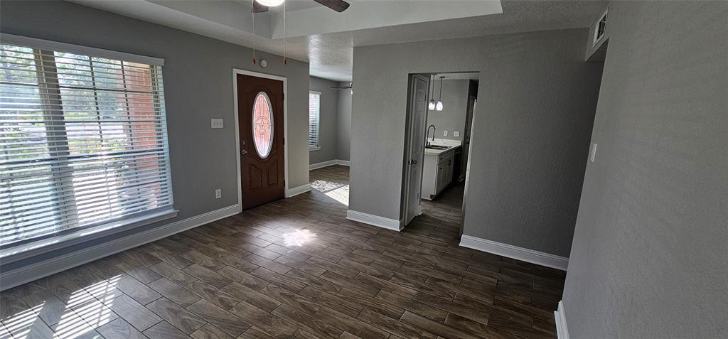 433 Ard Road Seagoville, TX 75159 - Photo 3 of 16 an empty room with wooden floor and windows