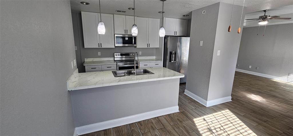 433 Ard Road Seagoville, TX 75159 - Photo 4 of 16 a kitchen with stainless steel appliances a refrigerator a stove a microwave and cabinets