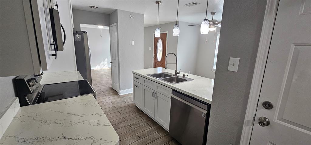 433 Ard Road Seagoville, TX 75159 - Photo 6 of 16 a kitchen with a sink stove and refrigerator