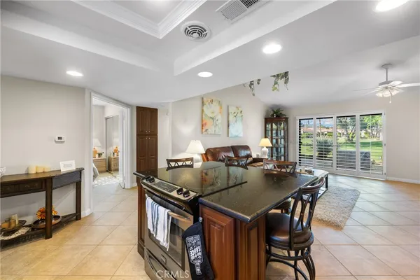 a kitchen with granite countertop a table and chairs a stove a sink with wooden floor