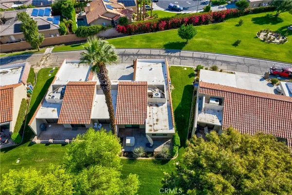 an aerial view of a house with garden space and street view