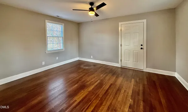 wooden floor in an empty room with a window