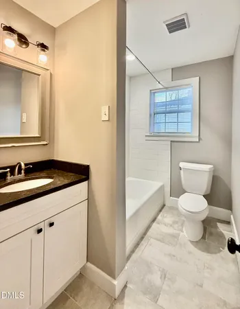 a bathroom with a sink vanity and a mirror