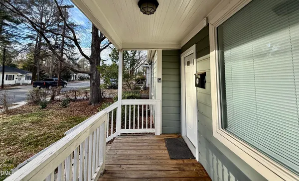 a view of balcony with wooden floor and fence