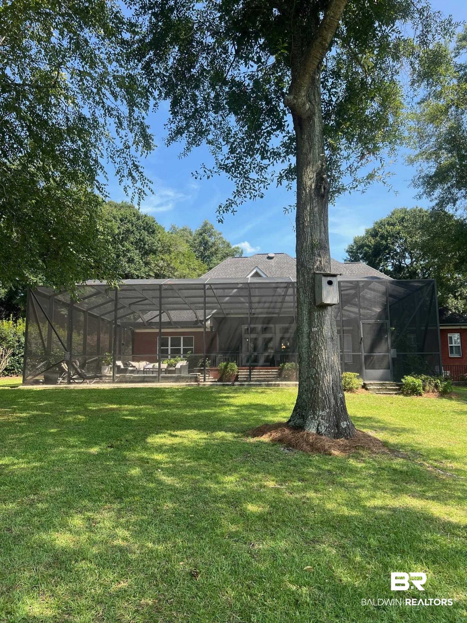 8775 Dawes Lake Road North Mobile, AL 36619 - Photo 51 of 59 View of grassy yard with a lanai