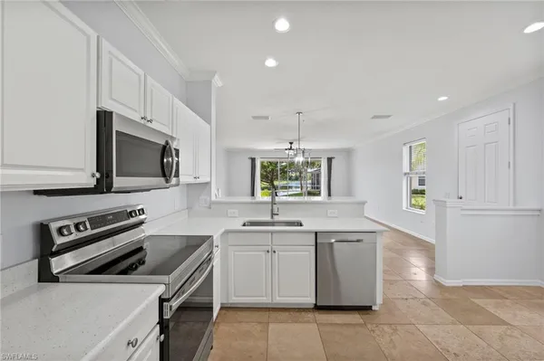 a kitchen with a sink stove and microwave