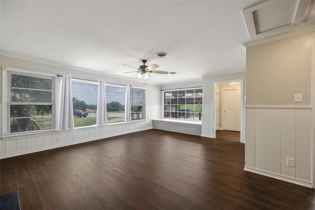 2323 Sutter Street Dallas, TX 75216 - Photo 15 of 30 Family room with crown molding, a wealth of natural light, dark wood-type flooring, and ceiling fan