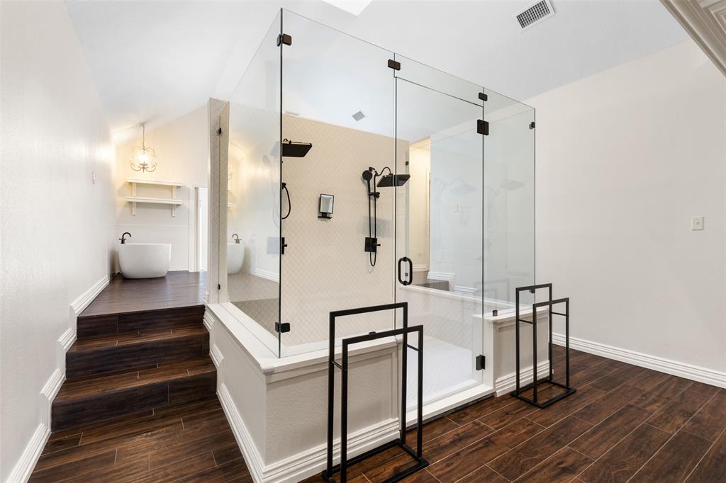609 Seville Road Denton, TX 76205 - Photo 23 of 40 Primary en-suite bathroom feels like a spa with this stunning oversized double shower & dual-side fireplace.