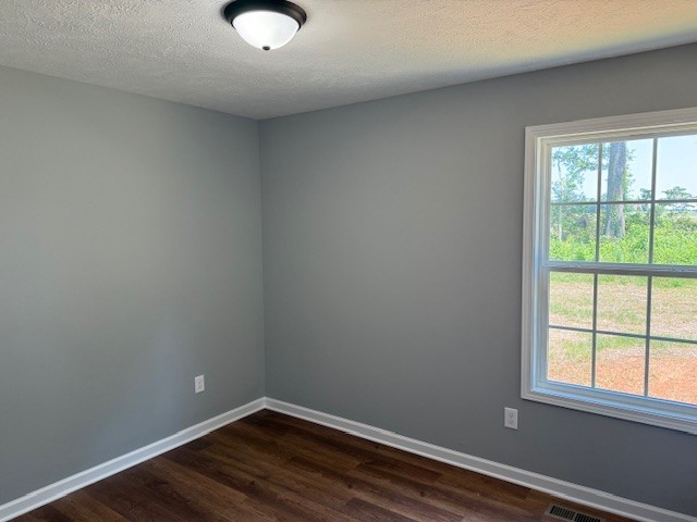 159 Hesselly Road Decherd, TN 37324 - Photo 11 of 11 wooden floor in an empty room with a window