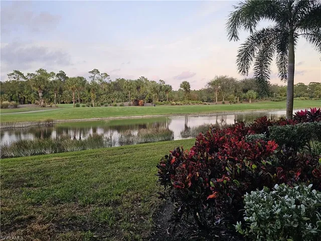 a view of a lake with a house in the background