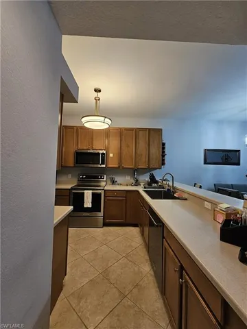 a large kitchen with a stove and a sink