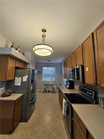 a kitchen with stainless steel appliances a stove refrigerator sink and cabinets