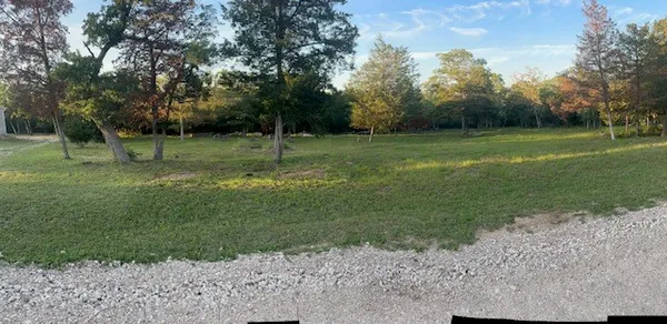 a backyard of a house with lots of green space