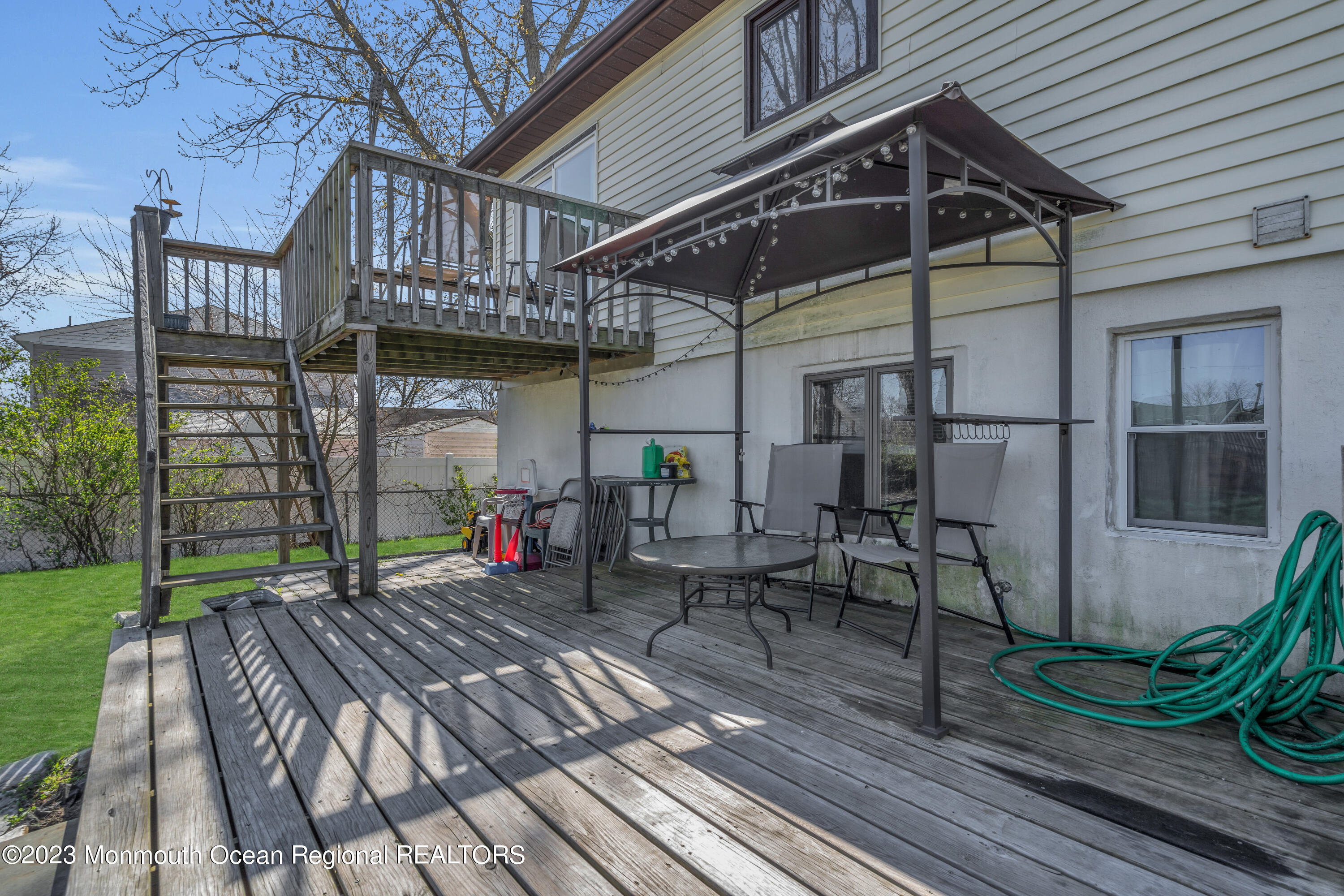 20 Woodlark Road Toms River, NJ 08755 - Photo 27 of 32 a view of a chairs and table on the wooden roof deck