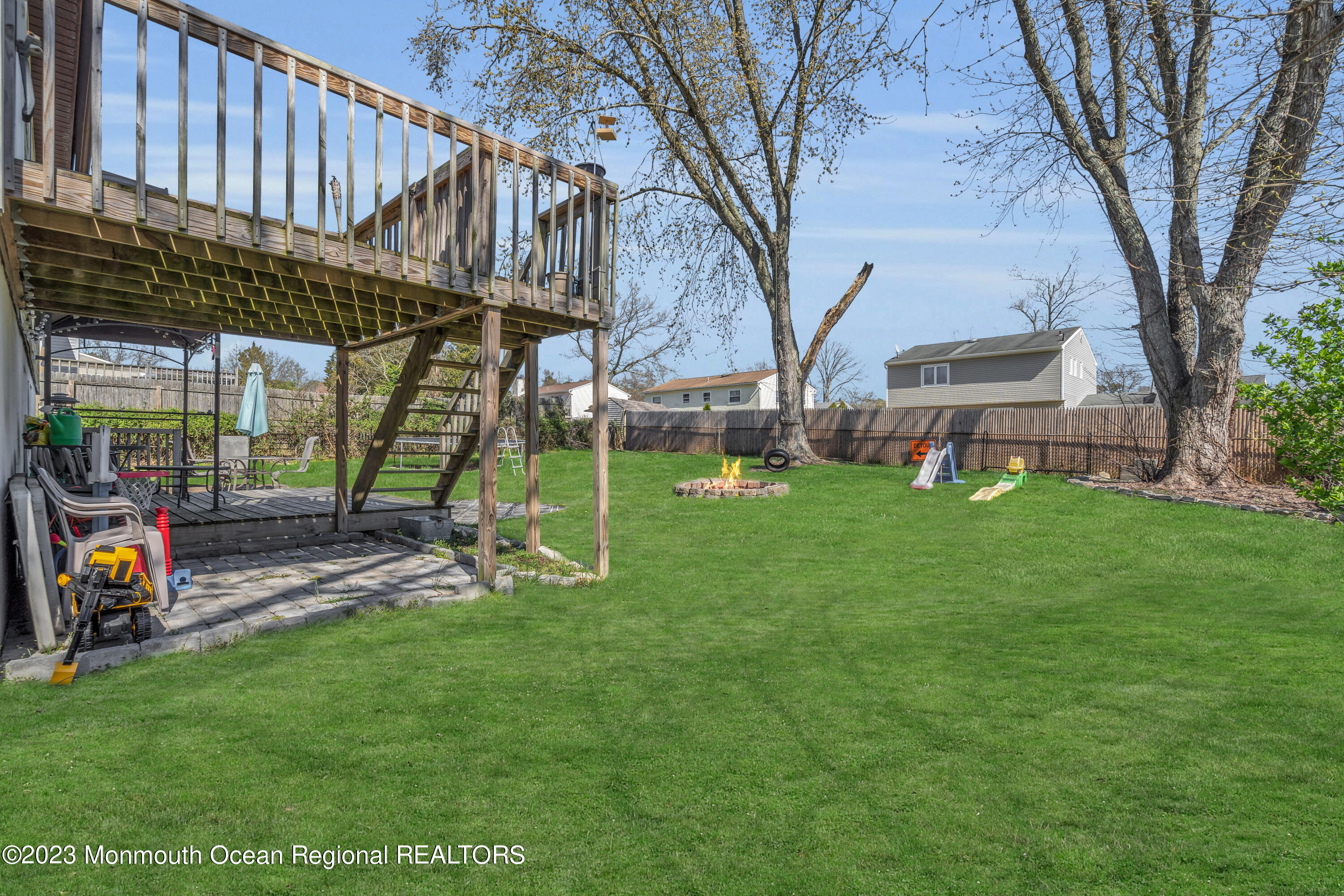 20 Woodlark Road Toms River, NJ 08755 - Photo 28 of 32 a view of a backyard with a table and chairs and a large tree
