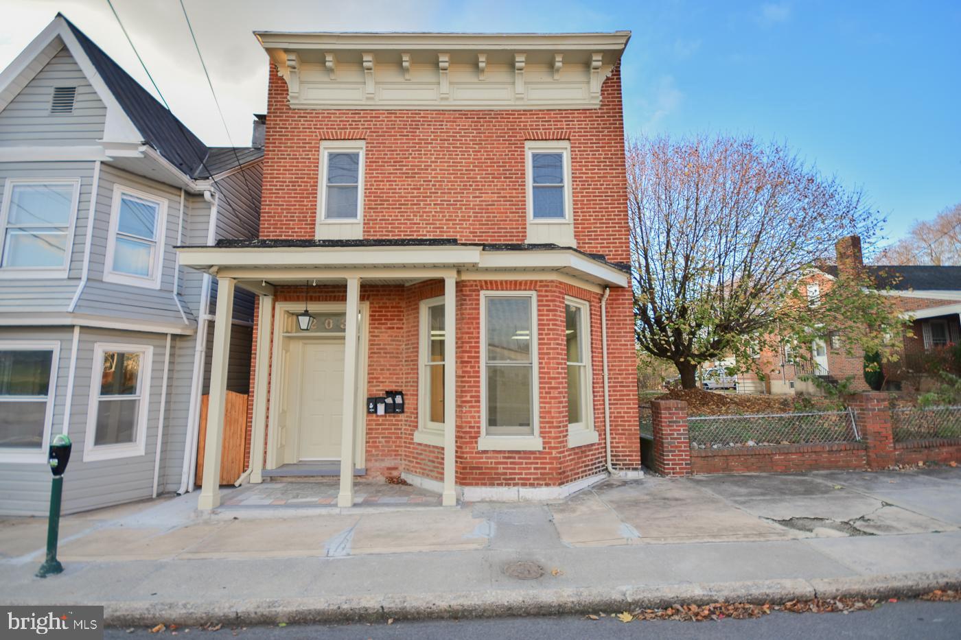 203 West John Street, Unit 4 Martinsburg, WV 25401 - Photo 1 of 17 a front view of a house with a yard