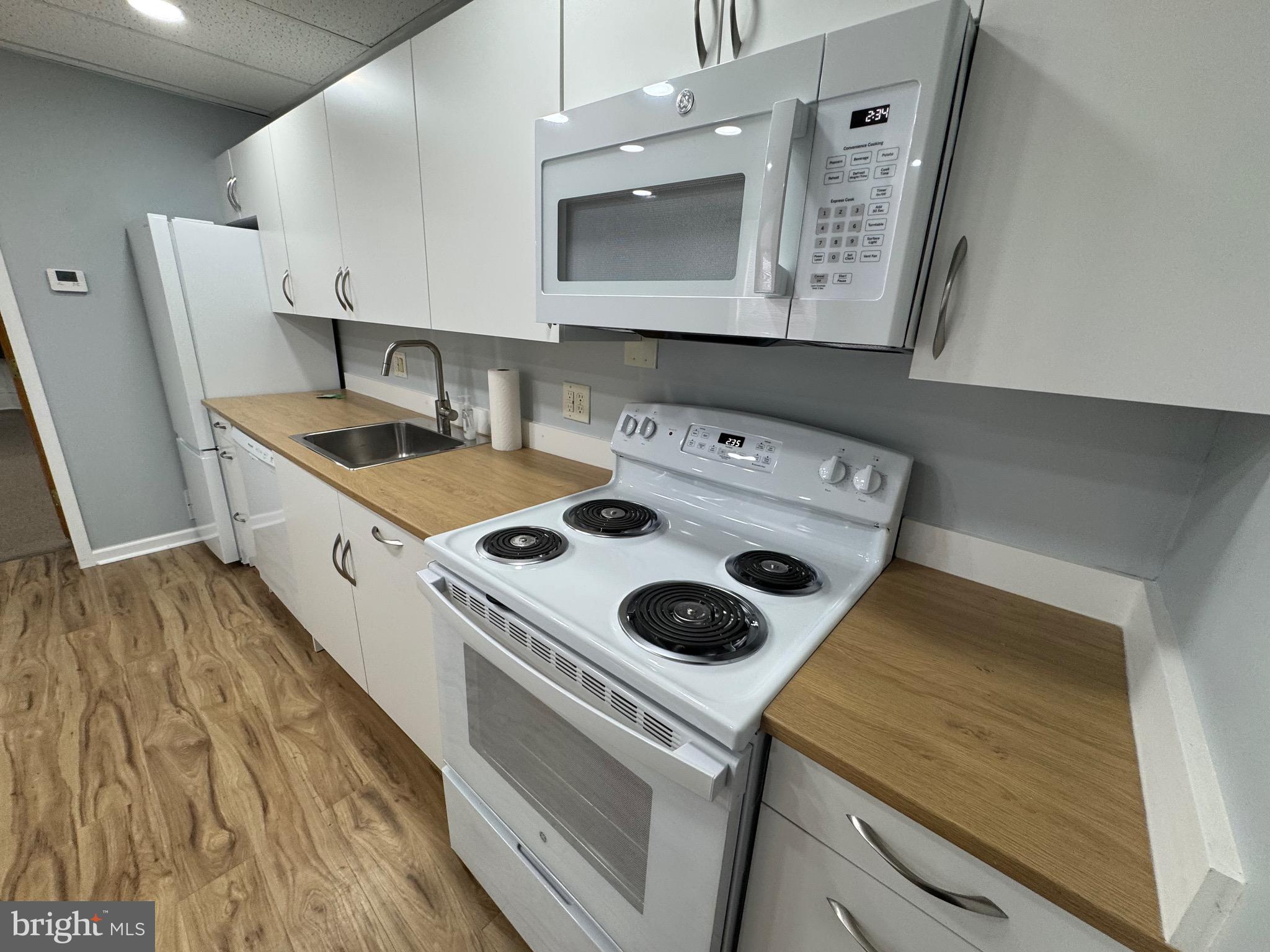 203 West John Street, Unit 4 Martinsburg, WV 25401 - Photo 12 of 17 a kitchen with a stove and a microwave