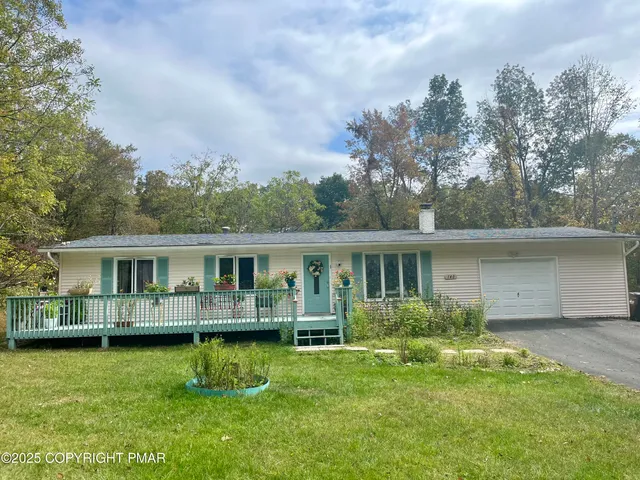 a front view of house with yard and green space