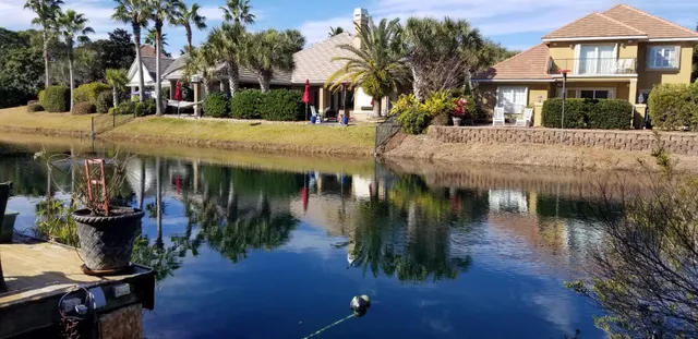 a view of a house with river next to a yard