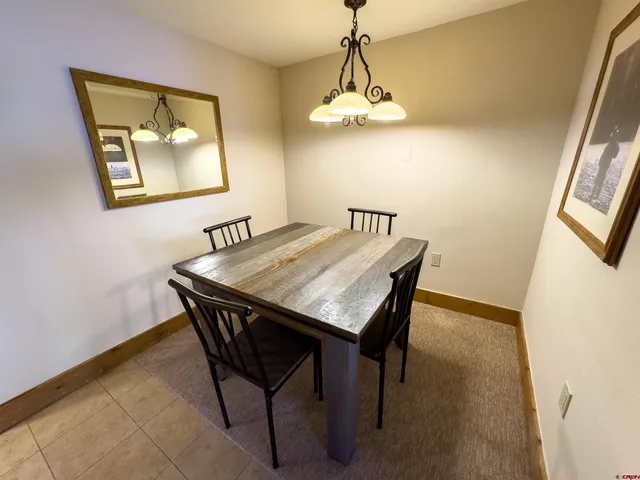 a dining room with a table and chairs