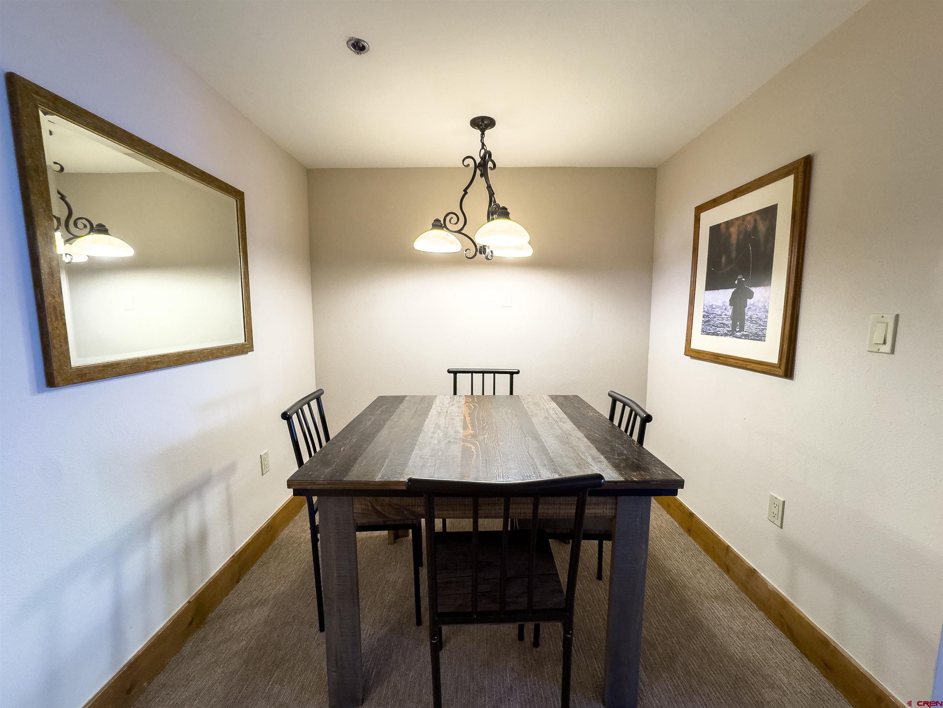6 Emmons Road, Unit 125 Crested Butte, CO 81225 - Photo 13 of 42 a dining room with a table and chairs