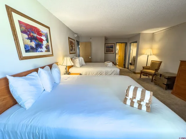 a spacious bedroom with a bed and a couch