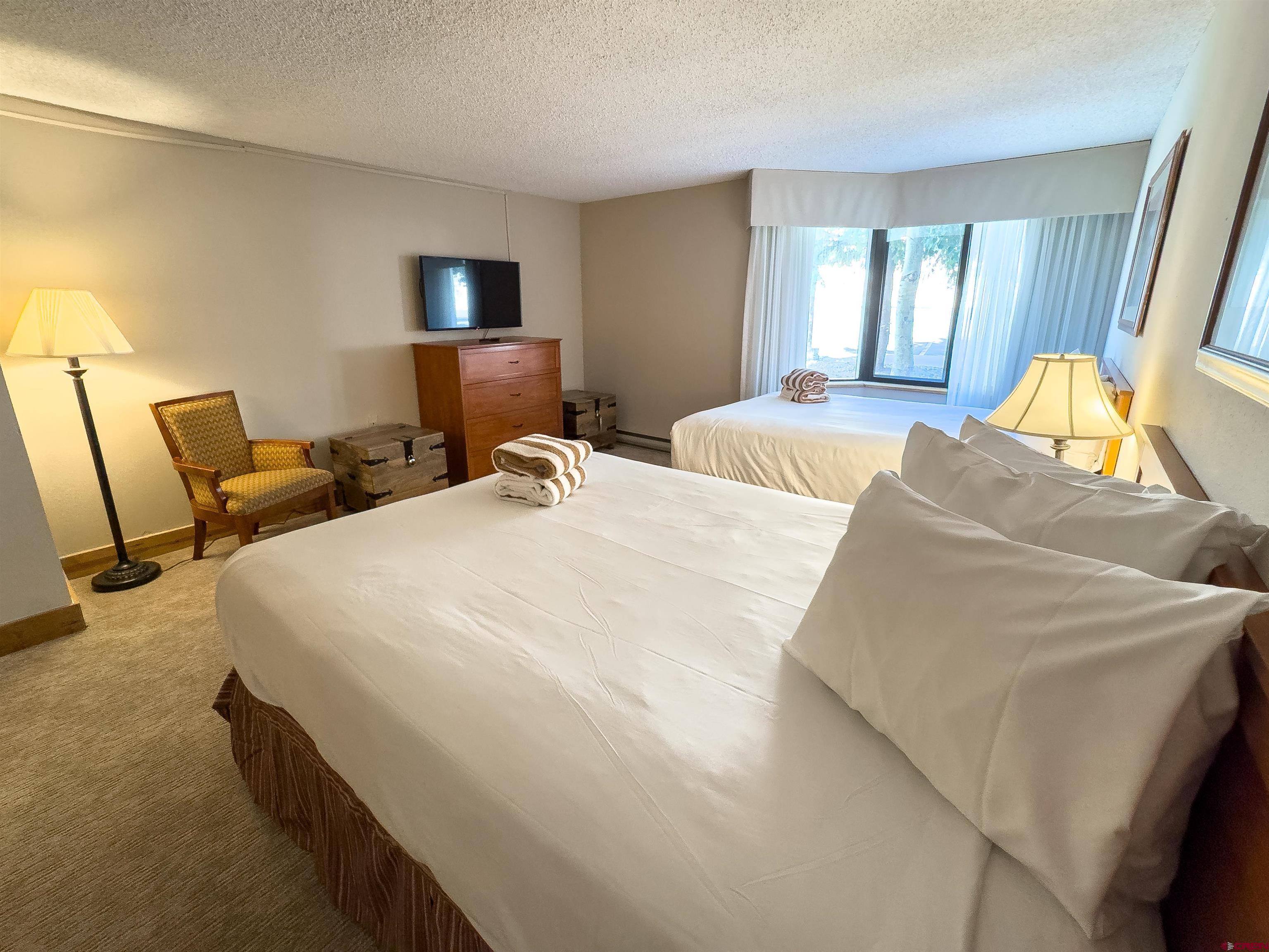 6 Emmons Road, Unit 125 Crested Butte, CO 81225 - Photo 31 of 42 a bedroom with bed and window