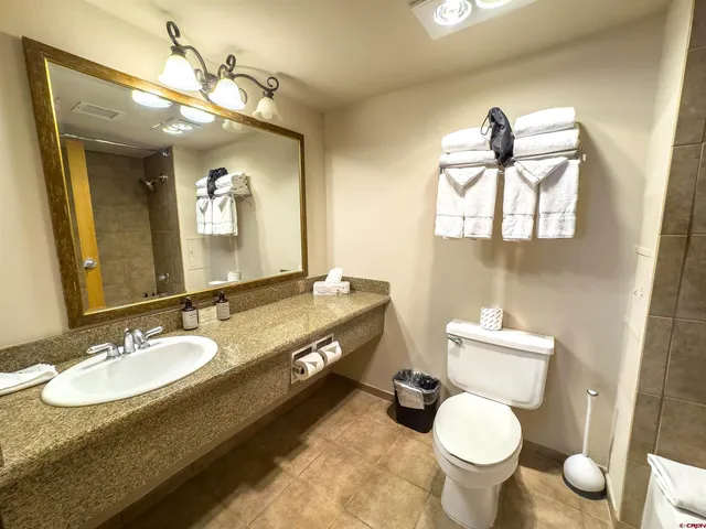 a en suite bathroom with a sink double vanity and a mirror