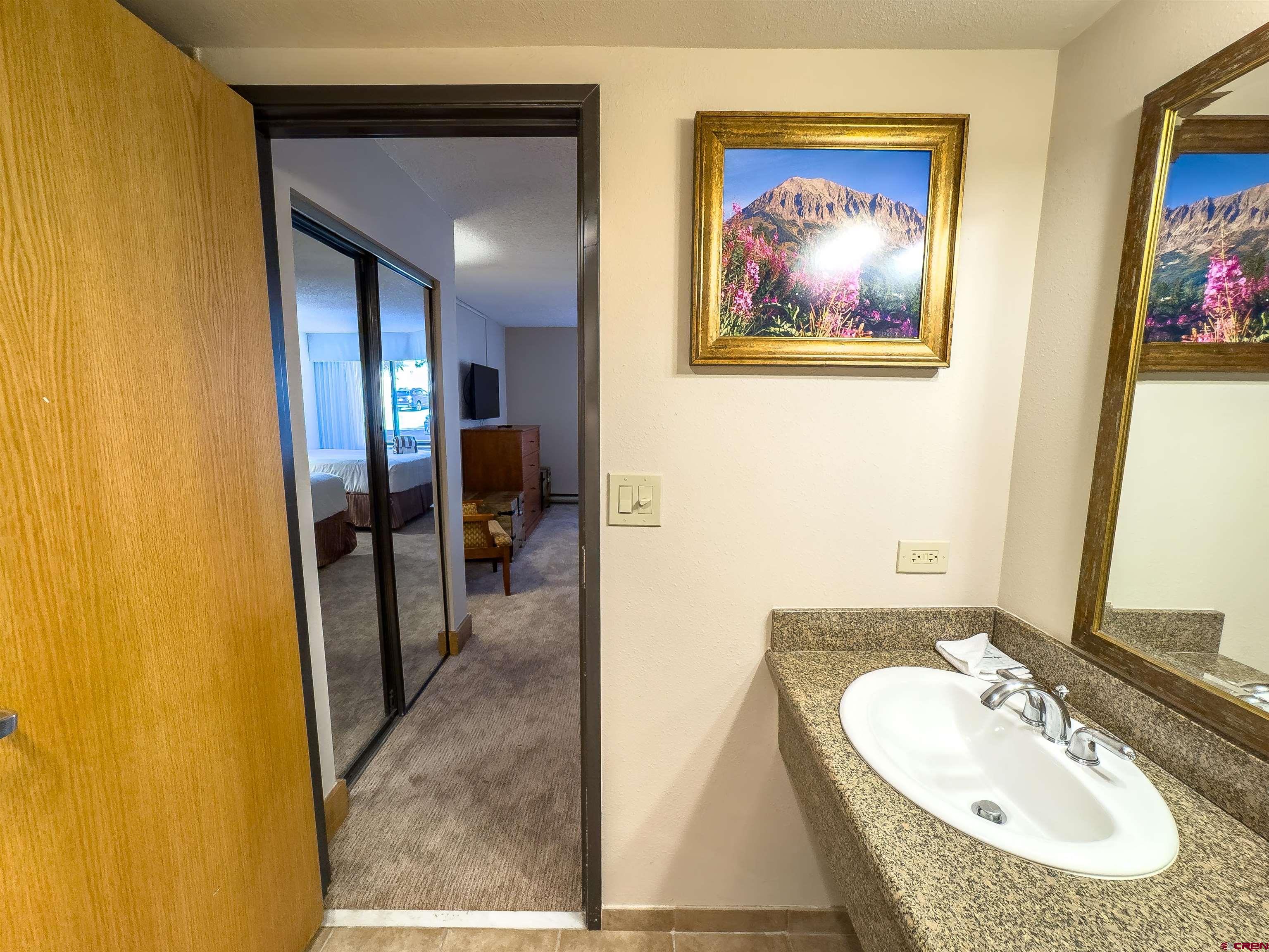 6 Emmons Road, Unit 125 Crested Butte, CO 81225 - Photo 36 of 42 a en suite bathroom with a sink double vanity and a mirror