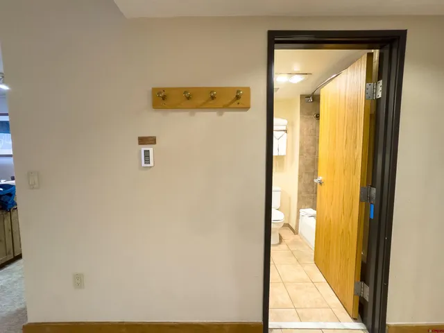 a bathroom with a granite countertop double vanity sink mirror and toilet
