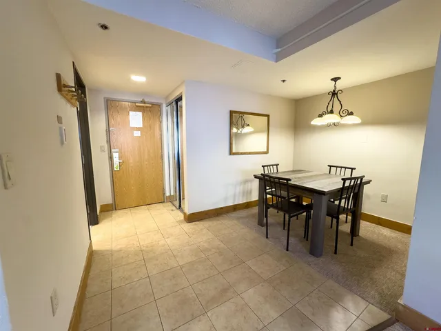 a dining room with furniture and window