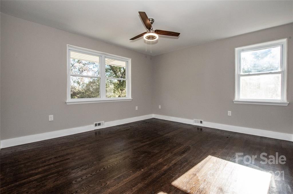 3748 Woodleaf Road Salisbury, NC 28147 - Photo 11 of 31 a view of an empty room with wooden floor and a window