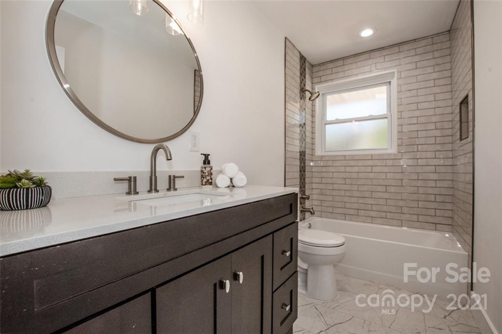 3748 Woodleaf Road Salisbury, NC 28147 - Photo 12 of 31 a bathroom with a sink a toilet and a mirror