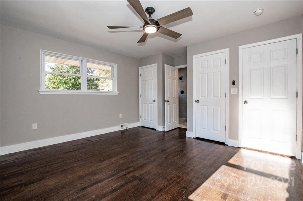 3748 Woodleaf Road Salisbury, NC 28147 - Photo 13 of 31 a view of an empty room with wooden floor and a ceiling fan