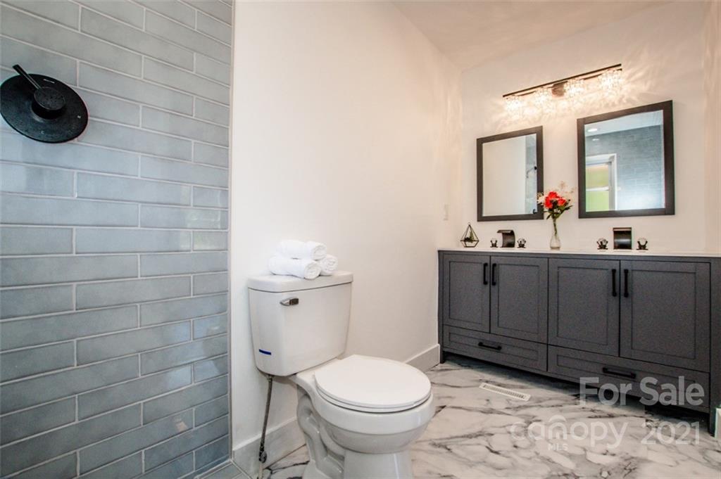 3748 Woodleaf Road Salisbury, NC 28147 - Photo 15 of 31 a bathroom with a toilet sink and mirror