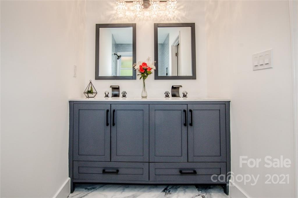 3748 Woodleaf Road Salisbury, NC 28147 - Photo 16 of 31 a bathroom with a sink vanity and mirror