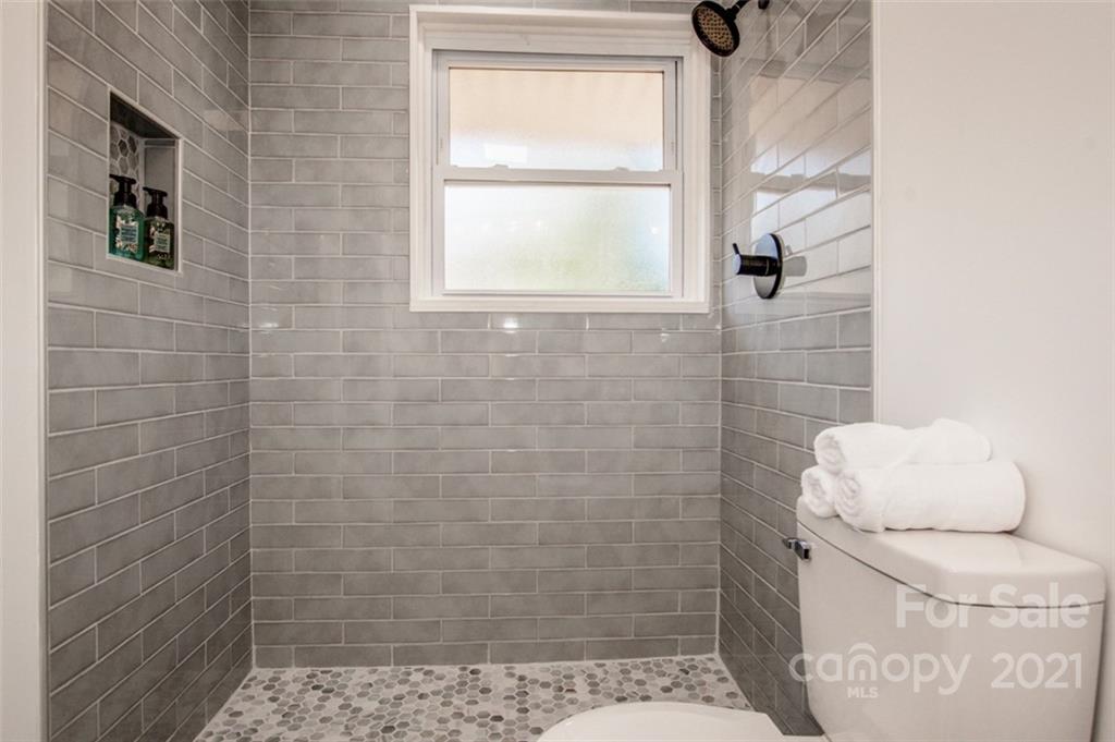 3748 Woodleaf Road Salisbury, NC 28147 - Photo 17 of 31 a bathroom with a toilet and a shower