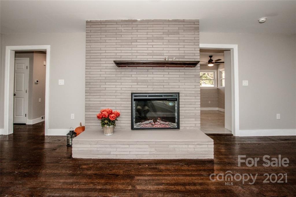 3748 Woodleaf Road Salisbury, NC 28147 - Photo 20 of 31 a living room with furniture and a fireplace